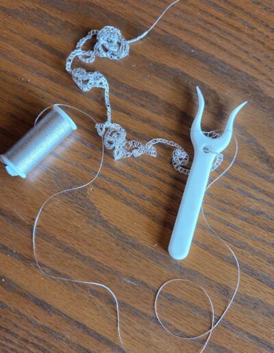 progress of silver embroidery floss to lucet cord for Juliet cap for pauper dress
