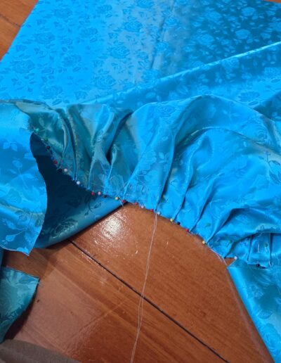 gathering the skirt sides of the pauper dress