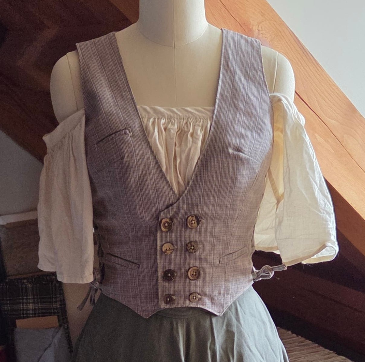 hobbit inspired green and grey cotton plaid vest with three welt pockets, double row of buttons, and size adjustable lace sides