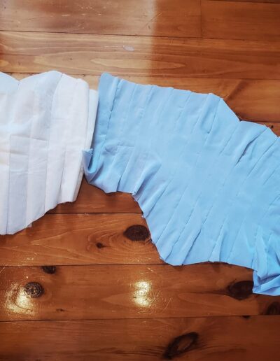 blue corset top being assembled